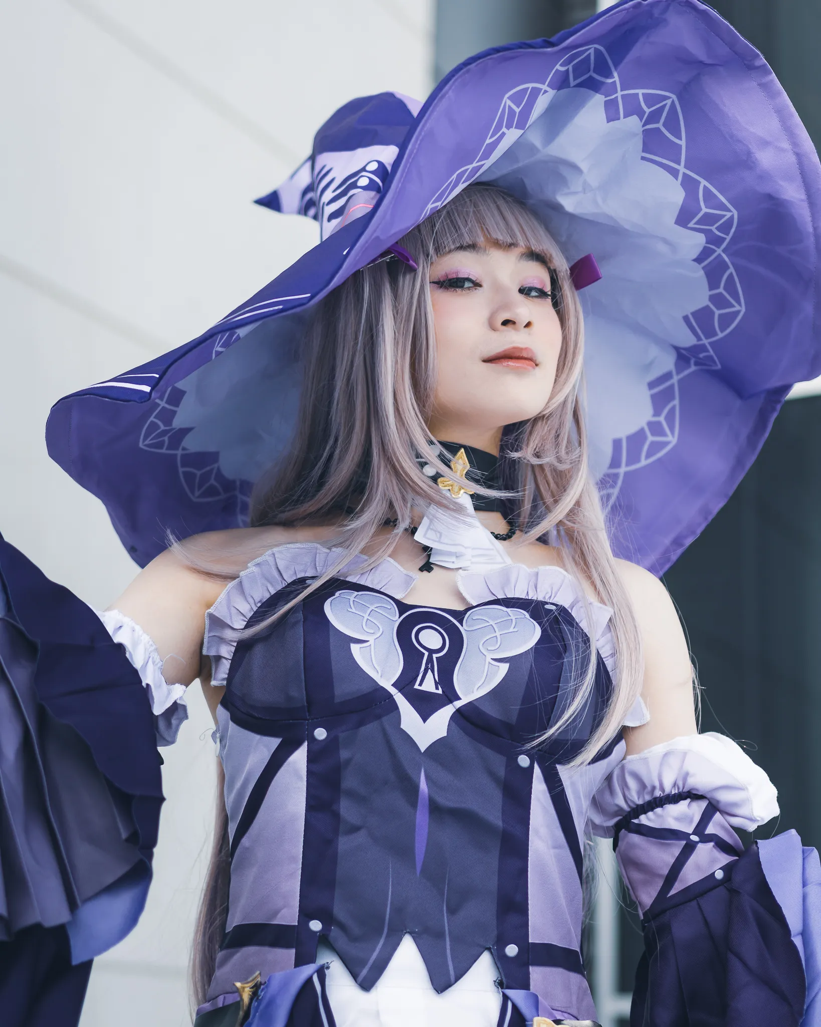 A cosplayer featuring the Herta from Honkai: Star Rail.