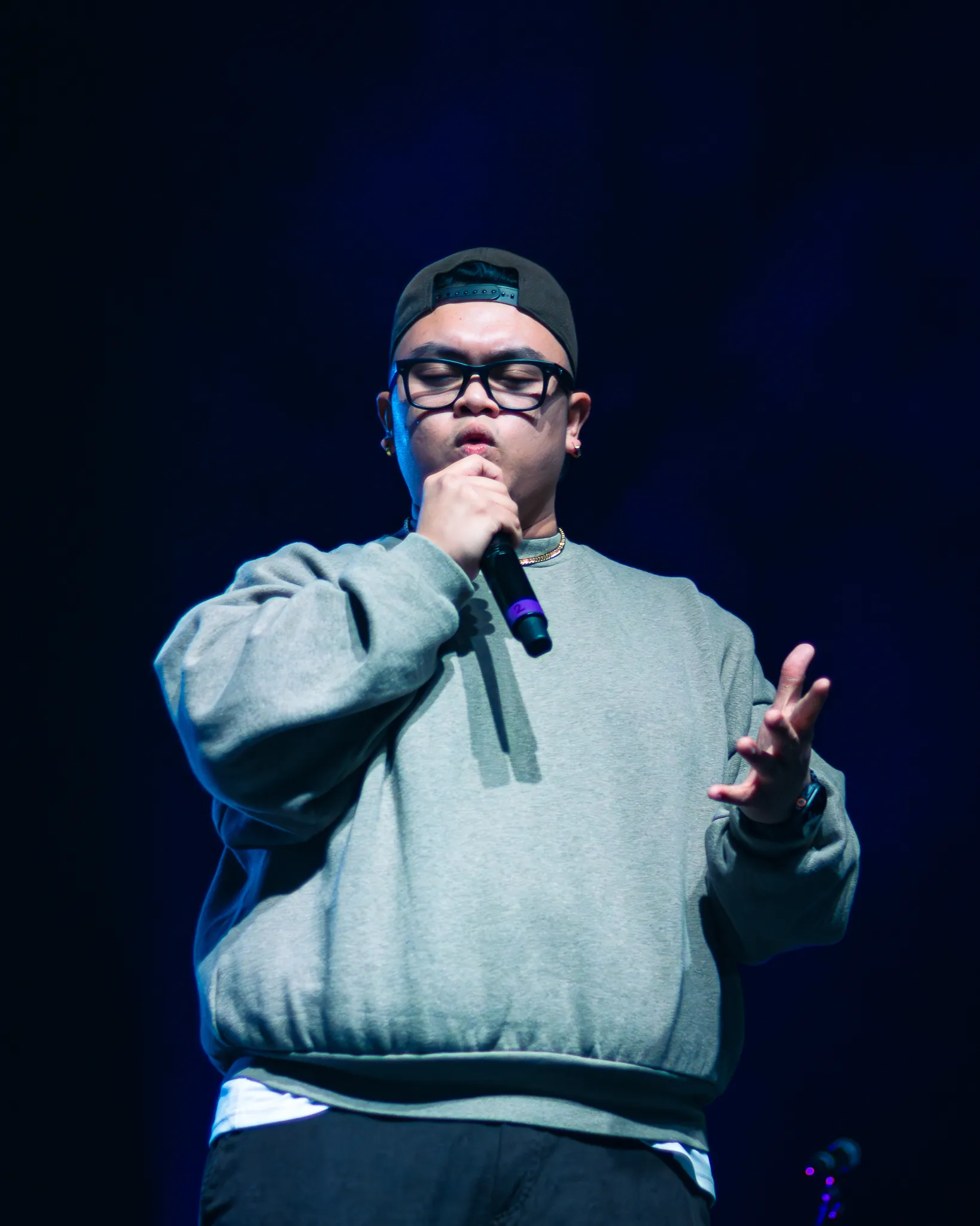 Aeron, an original filipino music artist who is performing on stage.