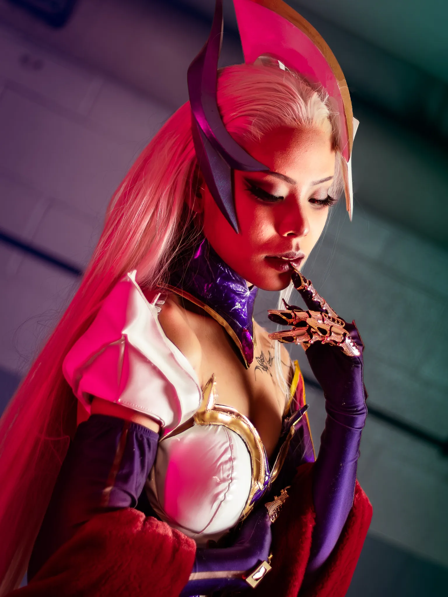 A cosplayer featuring Coven Evelynn from the massive multiplayer online battle arena: League of Legends.